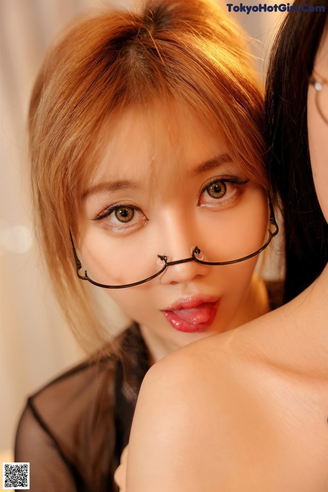 A woman wearing a pair of glasses is posing for a picture.